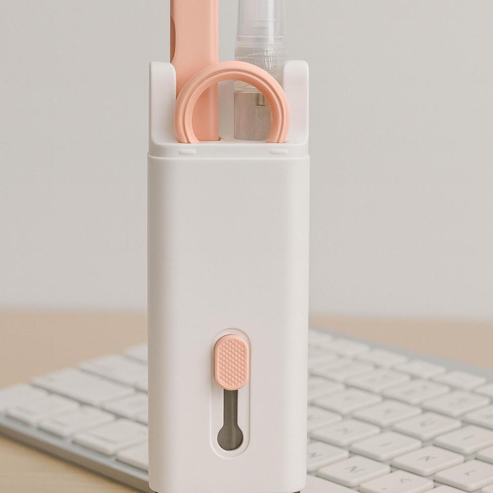 White and pink tech cleaning kit on a light gray background