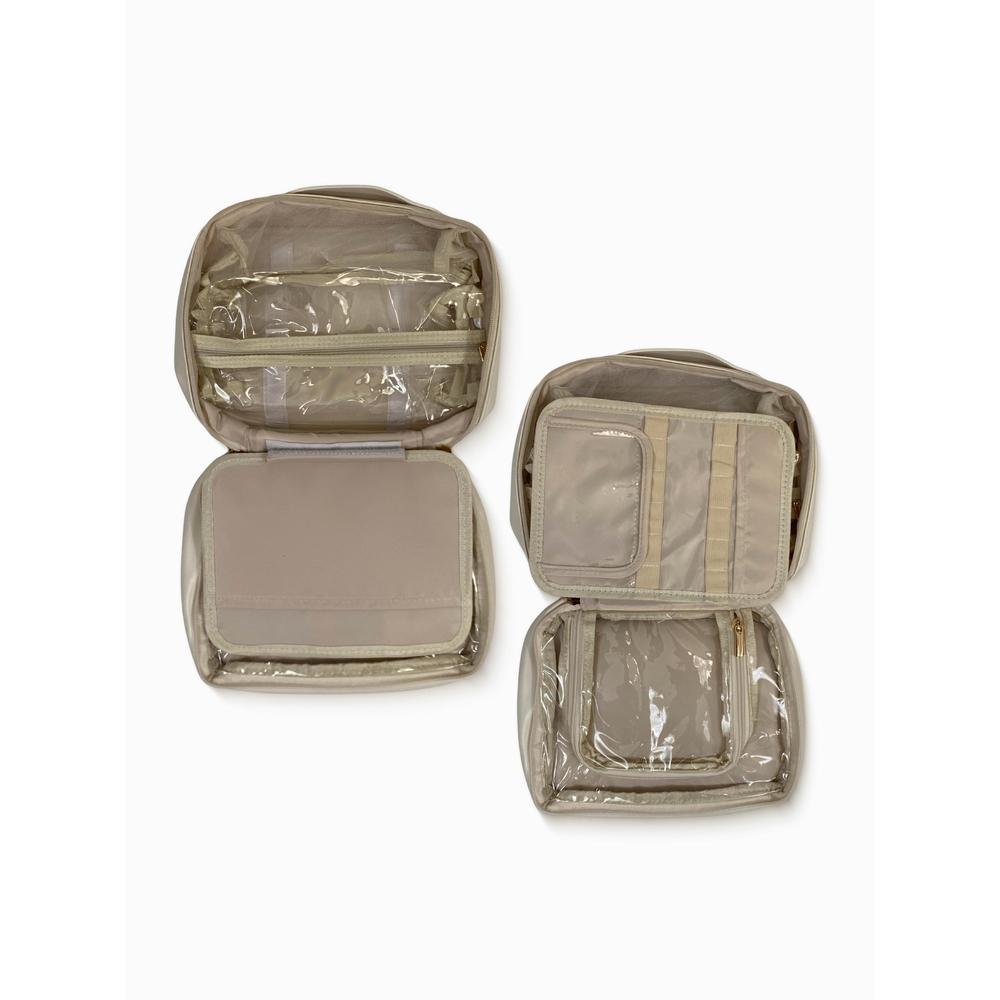 Set of beige travel organizers with clear compartments on a white background