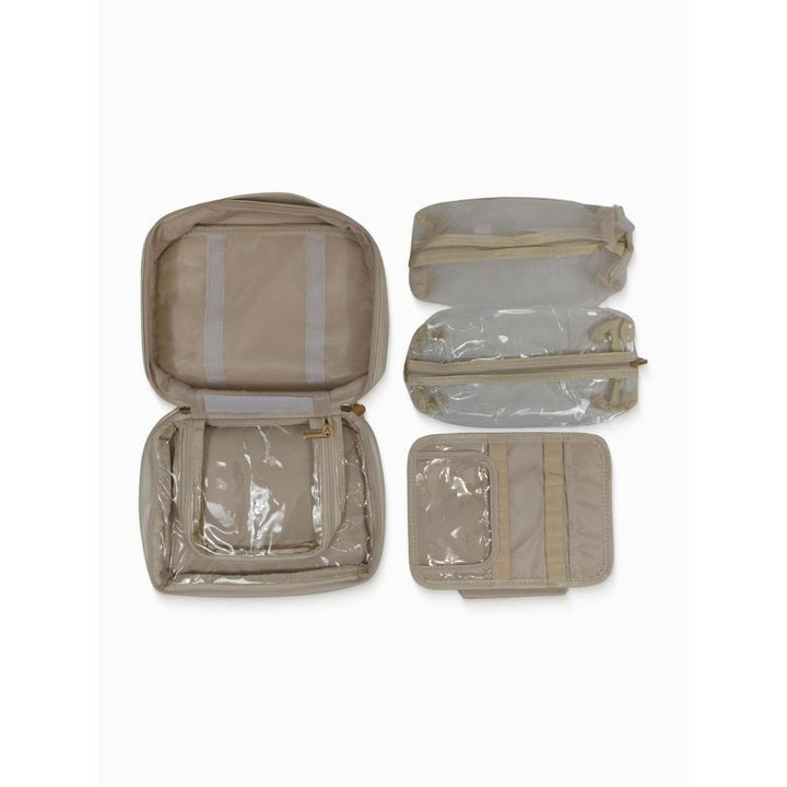 Beige toiletry organizer with clear sections on a white background