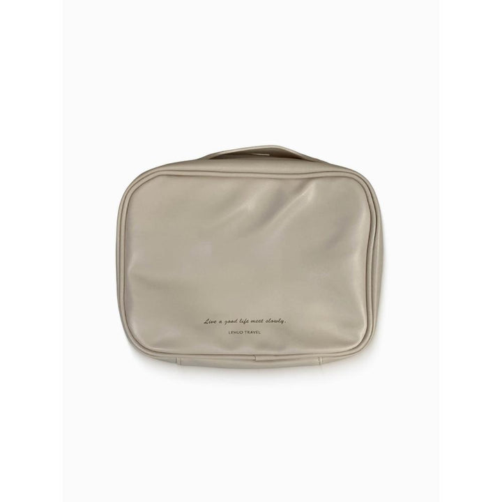 Beige toiletry bag with text on a white background