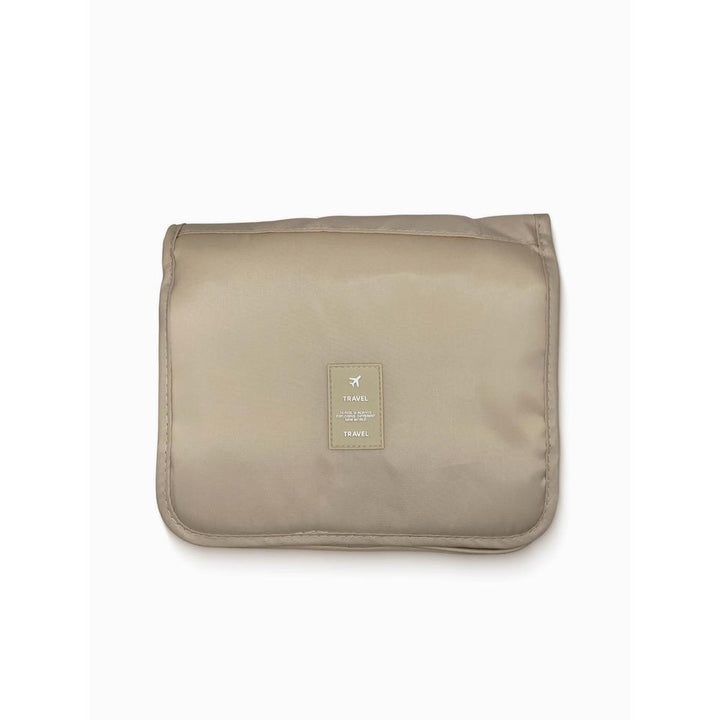 Beige travel pouch with a brand label on a white background