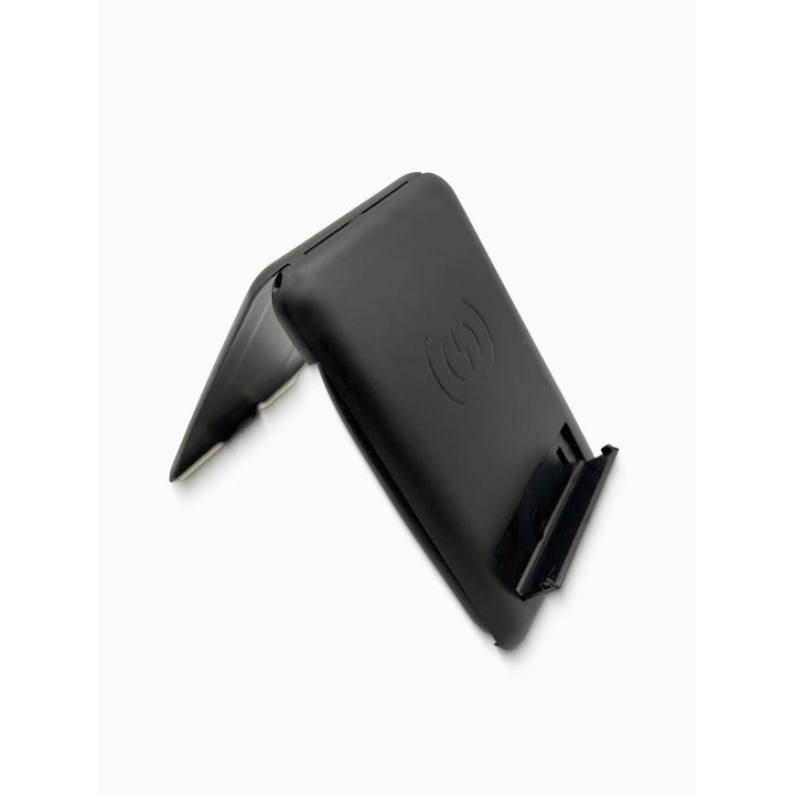 Black wireless charging stand on a white background